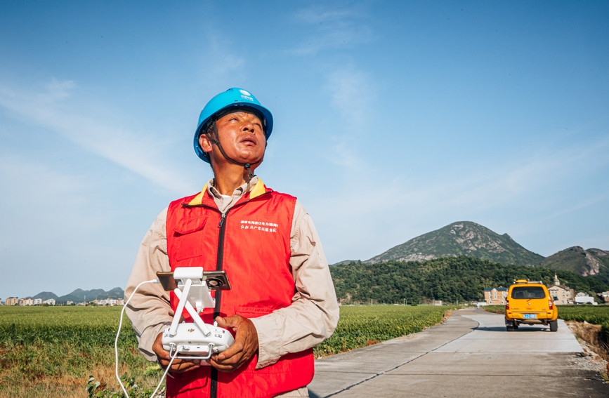 在臺州臨海桃渚，供電所員工頂著烈日，用無人機對田間線路進行巡視，并同步檢查農灌、農排等用電設備運行情況，指導農戶科學用電。陳貝靈攝