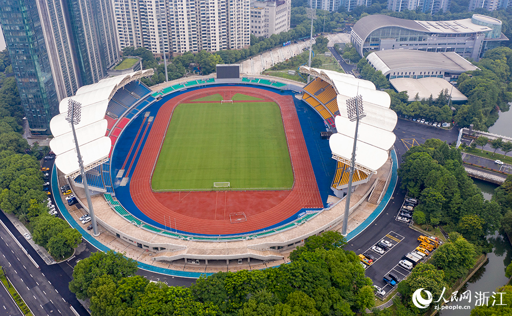 從空中俯瞰浙江省杭州市錢塘江畔的上城區體育中心，鮮艷的紅藍塑膠田徑跑道與鋪設了大片綠色草皮的足球場相映成景。人民網 章勇濤攝